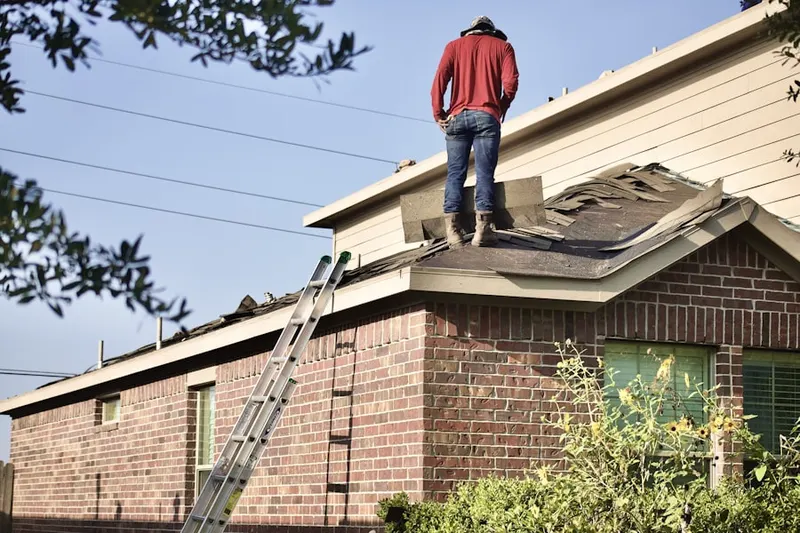 Professional roofer working on a residential roof in Pin Oak Estates